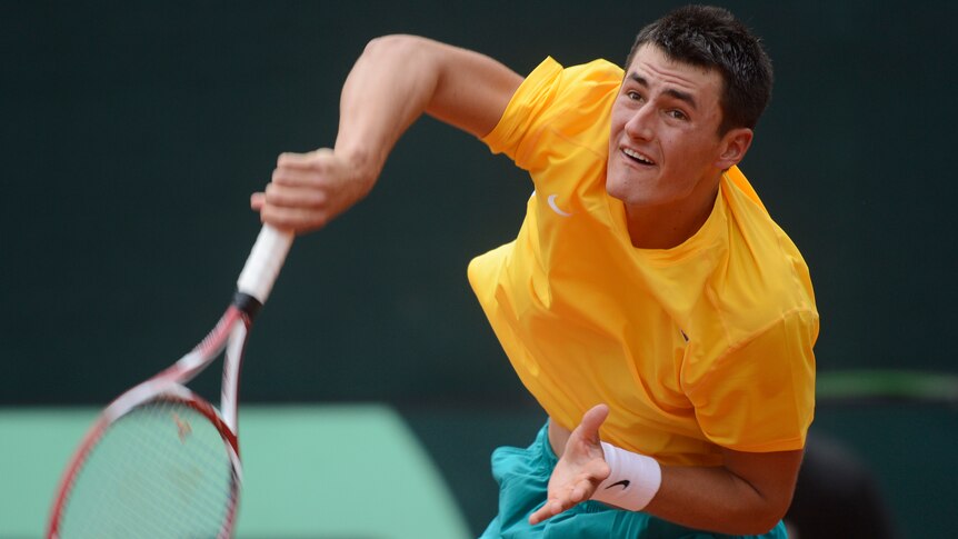 Tomic serves in Davis Cup