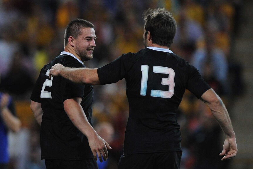 New Zealand's Dane Coles (L) and Conrad Smith celebrate a try against Australia at Lang Park.