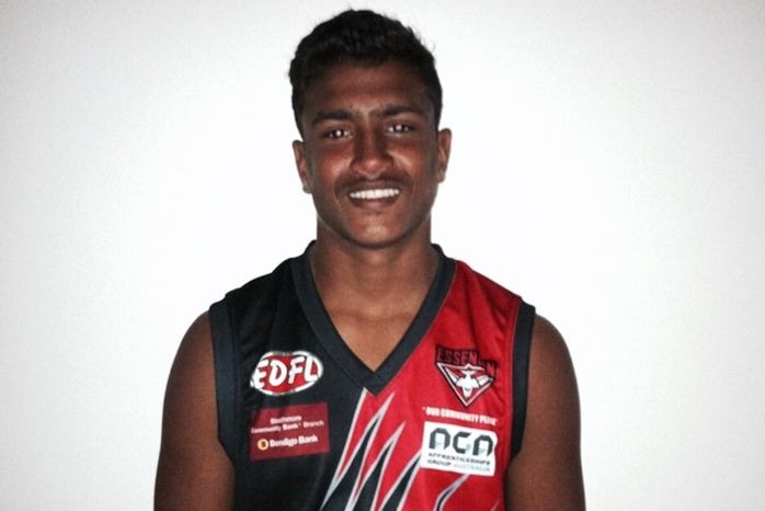 A footy portrait of a young man wearing a red and white footy jumper.