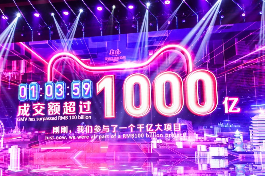 A big purple screen shows the online sales for e-commerce giant Alibaba.