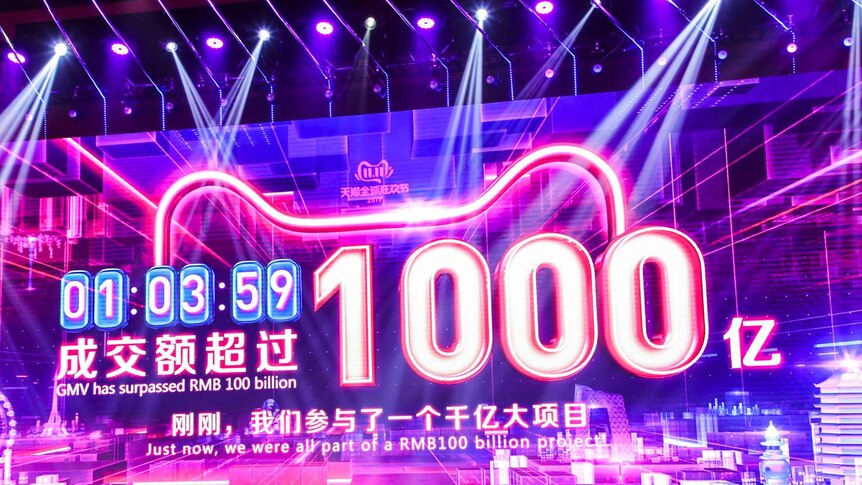 A big purple screen shows the online sales for e-commerce giant Alibaba.