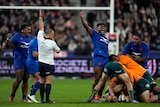 French rugby union players roar in triumph, as the referee blows full-time in a Test against Australia.