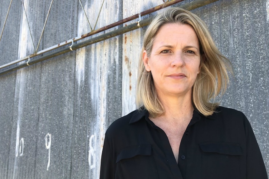 Strawberry industry development officer Jennifer Rowling stands in front of a farm shed.