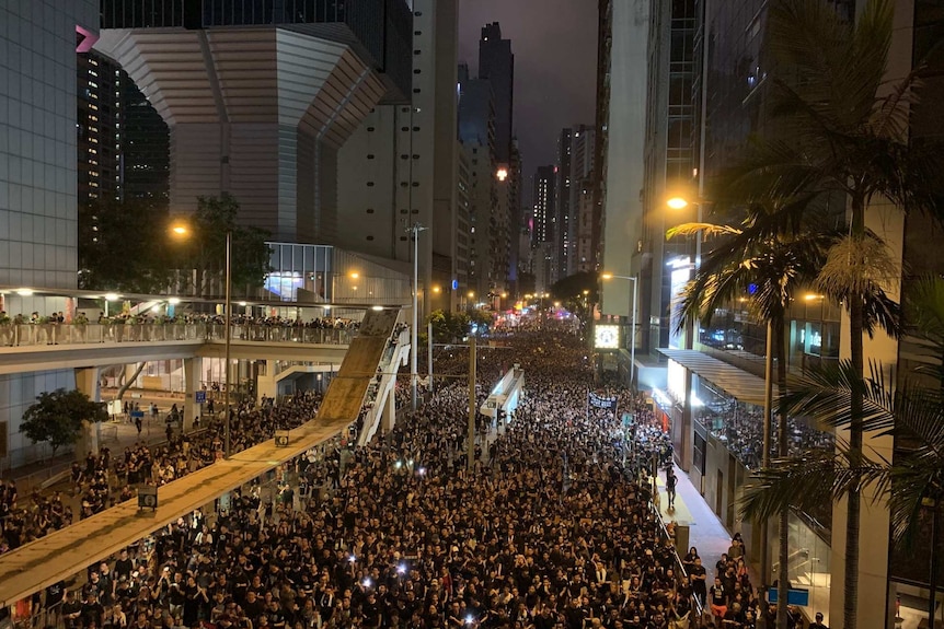 Hundreds of thousands of people fill up the streets of urban Hong Kong at night