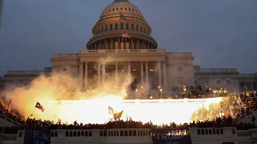 An explosion caused by a police munition in front of the US Capitol building during a Trump supporter riot.