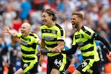 Huddersfield Town's Aaron Mooy, Michael Hefele and Martin Cranie celebrate after winning the Championship Play-Off Final.