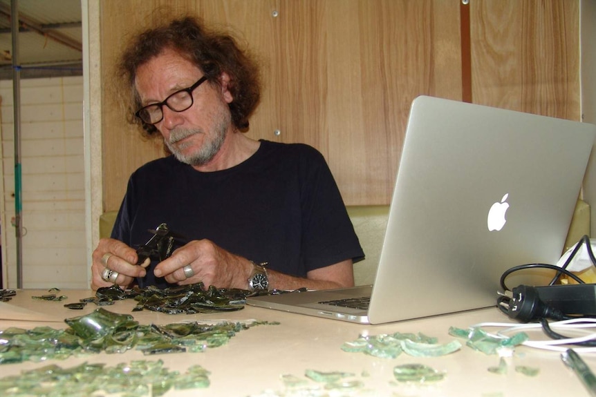 Professor Bryce Barker analysing artefacts from Boralga near Laura in Queensland's far north.