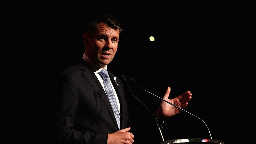 Mike Baird on stage speaking into a microphone