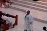A video shows a Filipino priest on a hoverboard during mass.