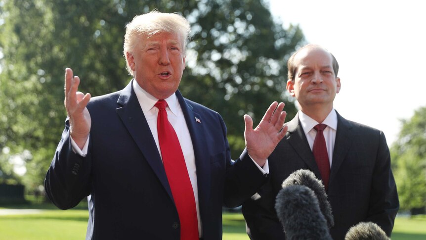 President Donald Trump speaks to members of the media with Secretary of Labor Alex Acosta.