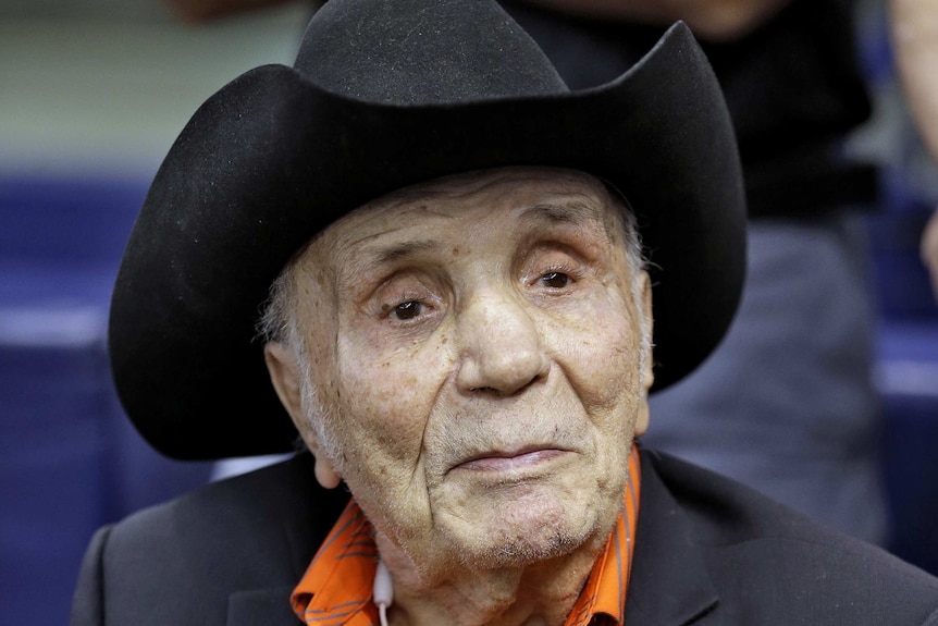 Jake LaMotta watches batting practice before a baseball game.