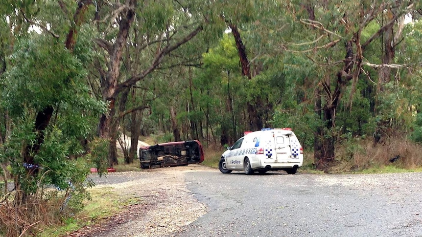 Car on its side after police chase at Macedon