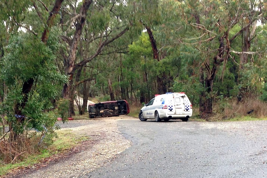 Car on its side after police chase at Macedon