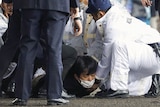 Man held down by police.