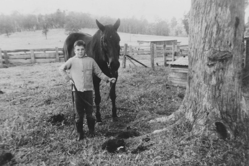 Black and white photo of 10-year-old Robbie Gambley and his horse