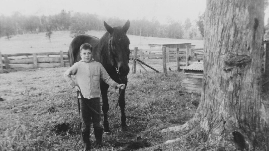 Black and white photo of 10-year-old Robbie Gambley and his horse