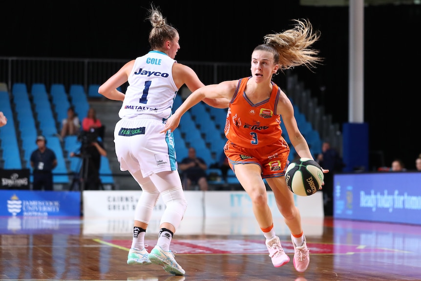 Stephanie Reid bounces the basketball around an opponent.