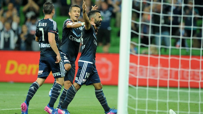 Melbourne Victory's Fahid Ben Khalfallah (R) celebrates his goal against Perth Glory.