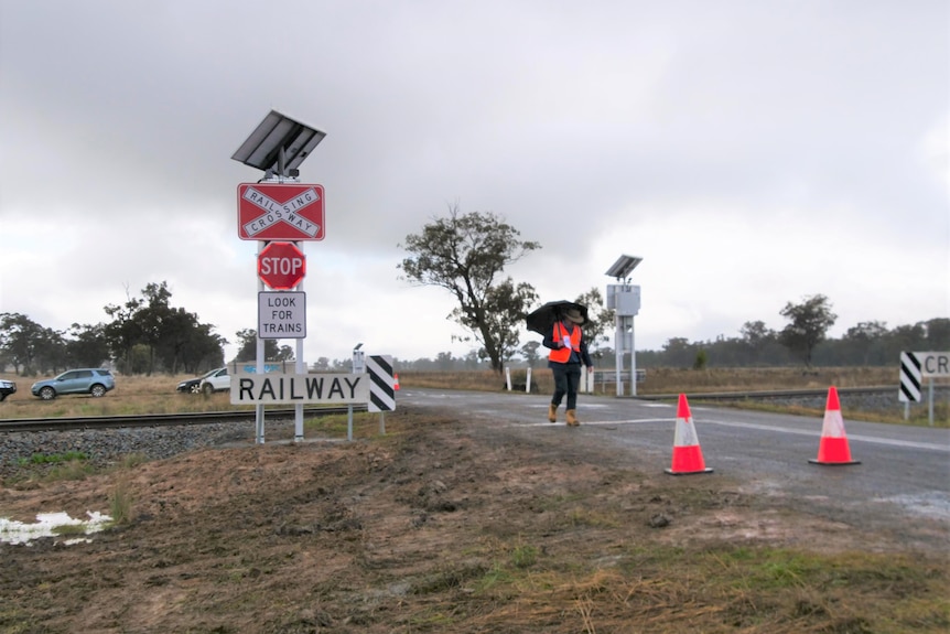 candid image of a railway crossing with new safety signs.