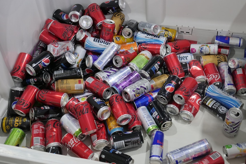 An image of a large industrial bin of empty aluminium drink cans.