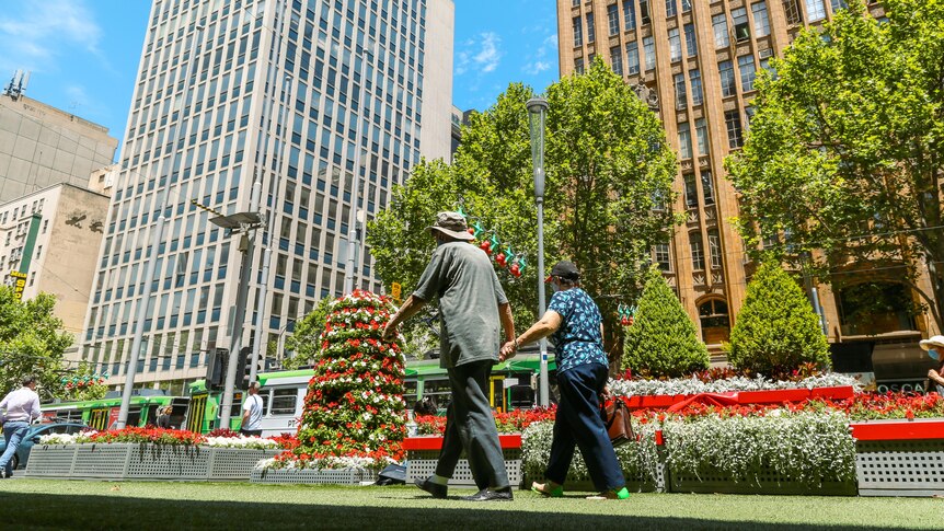 A couple walking in Melbourne's CBD.