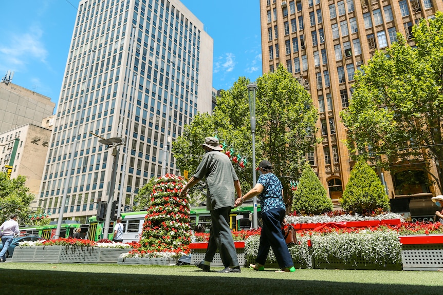 A couple walking in Melbourne's CBD.