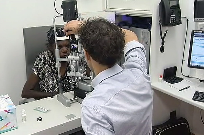 An ophthalmologist examines an indigenous woman's eyes.