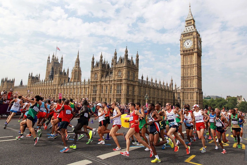 A group of marathon runners in front of Big Ben in London.