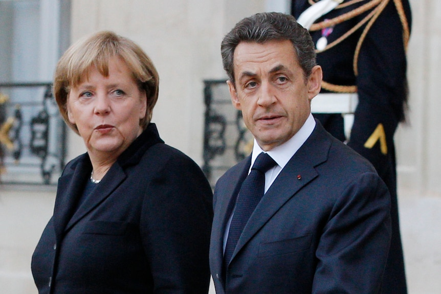 France's president Nicolas Sarkozy escorts German chancellor Angela Merkel following a joint news conference