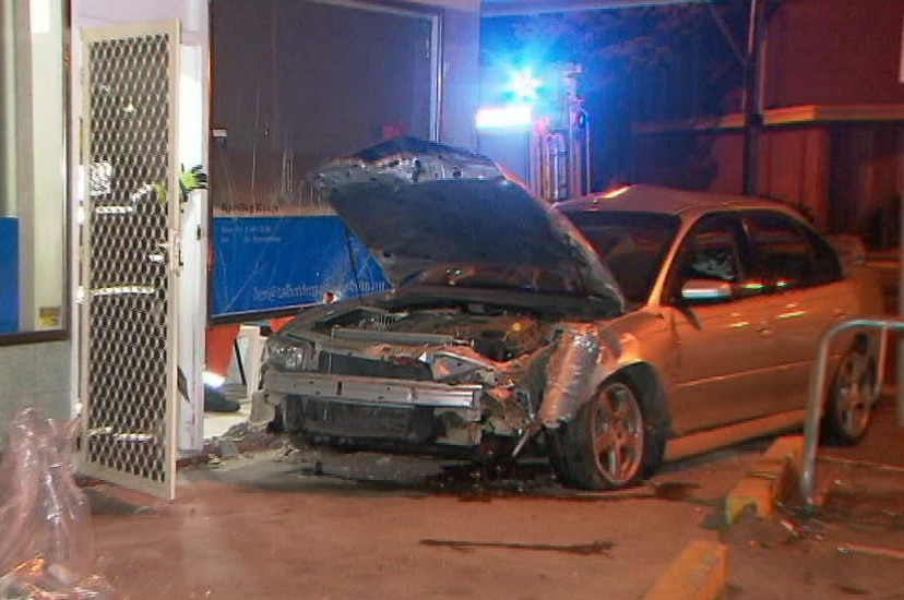 Damage on the front of a silver commodore which crashed into a building