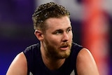 Cam McCarthy of Fremantle Dockers squats during an AFL game.