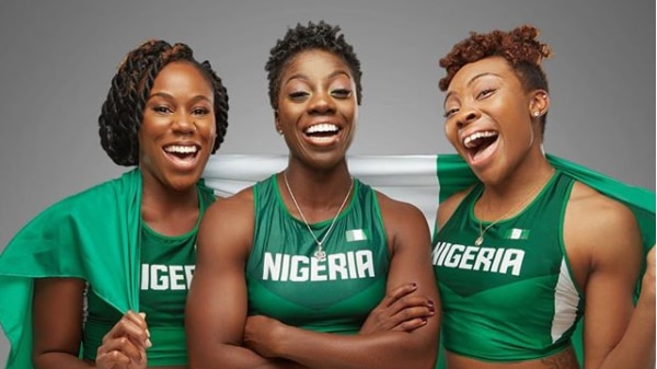 Three women wearing Nigerian sport uniforms.