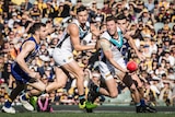 Brad Ebert of Port Adelaide handballs against West Coast Eagles at Subiaco Oval on July 9, 2017.