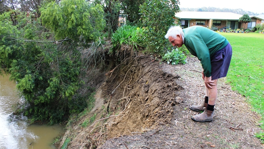 Geoff McCaw inspects an eroded creek bed at Foster, South Gippsland.