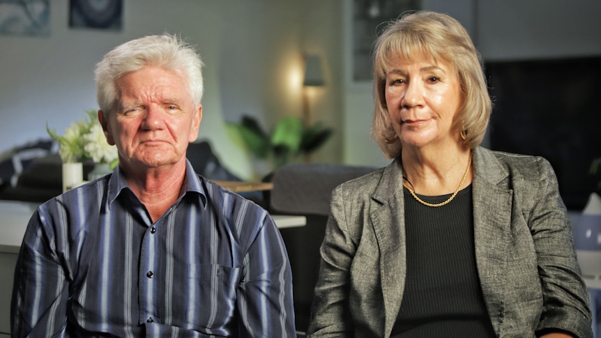 A man and woman sit next to each other.