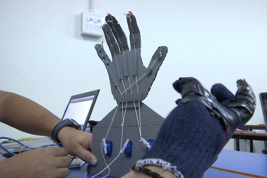 Mechatronics studies tinker with robotic hands, controlled by sensors wires into a glove so it moves as they flex their fingers.