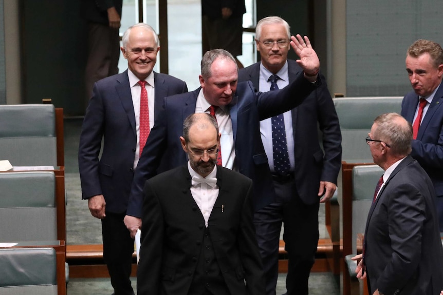 Barnaby Joyce, accompanied by usher and Malcolm Turnbull, returns to Lower House