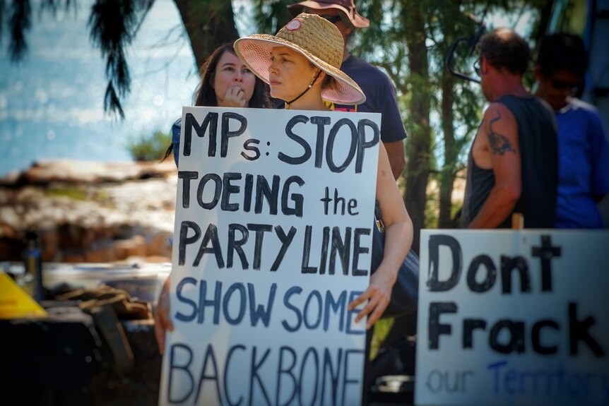A placard says 'MPs: Stop toeing the party line show some backbone'