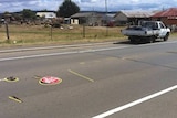 A stop sign lies on a Launceston road where a worker was hit by a car.