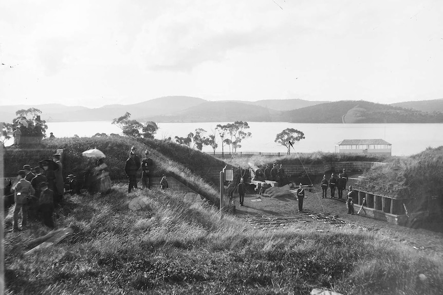A black and white photograph of artillery emplacements and soldiers, dated 1880.