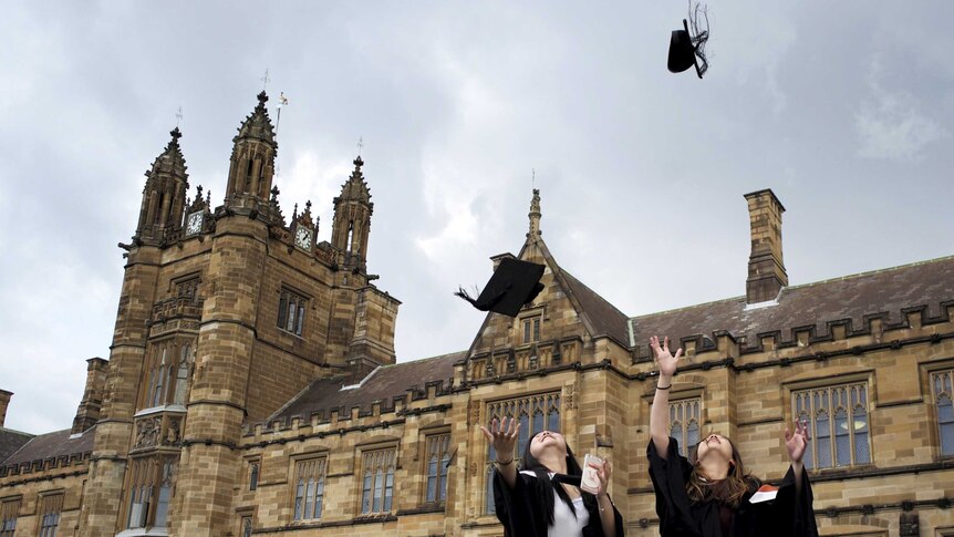 University students toss their graduation hats into the air