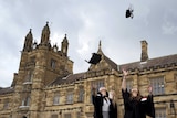 University students toss their graduation hats into the air