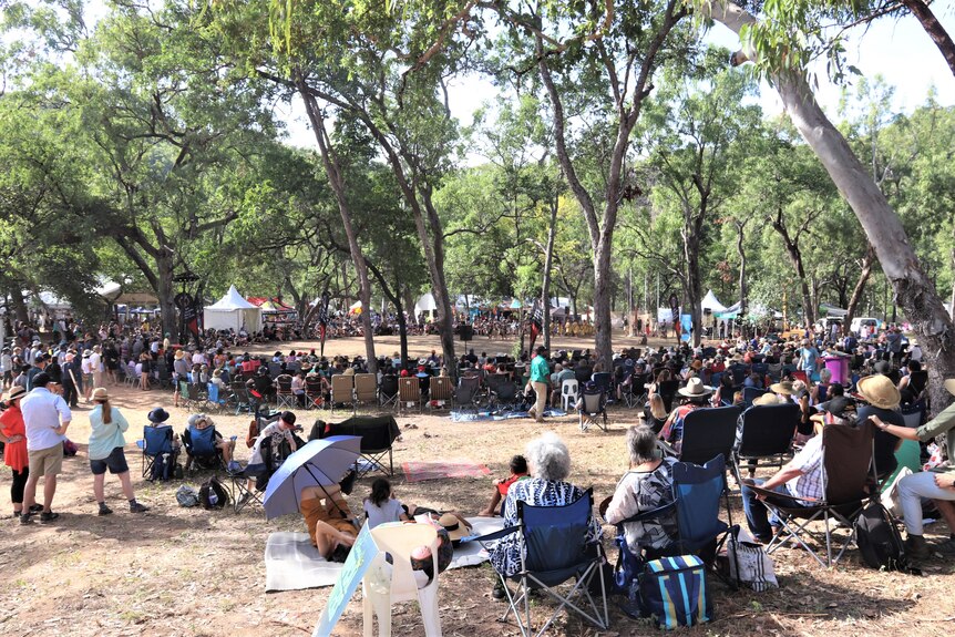 People sit in a circle around a natural stage, the 'bora' ground, to listen to traditional owners