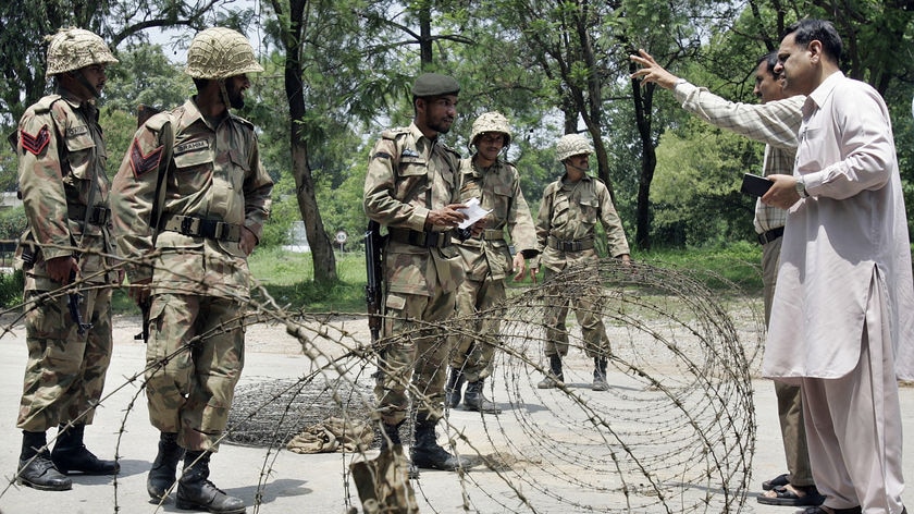 Soldiers stand guard near a barrier of barbed wire surrounding the Red Mosque in Islamabad.