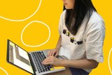 A woman sitting in front of a computer with a yellow background, in a story about racism at work and experiences of reporting.