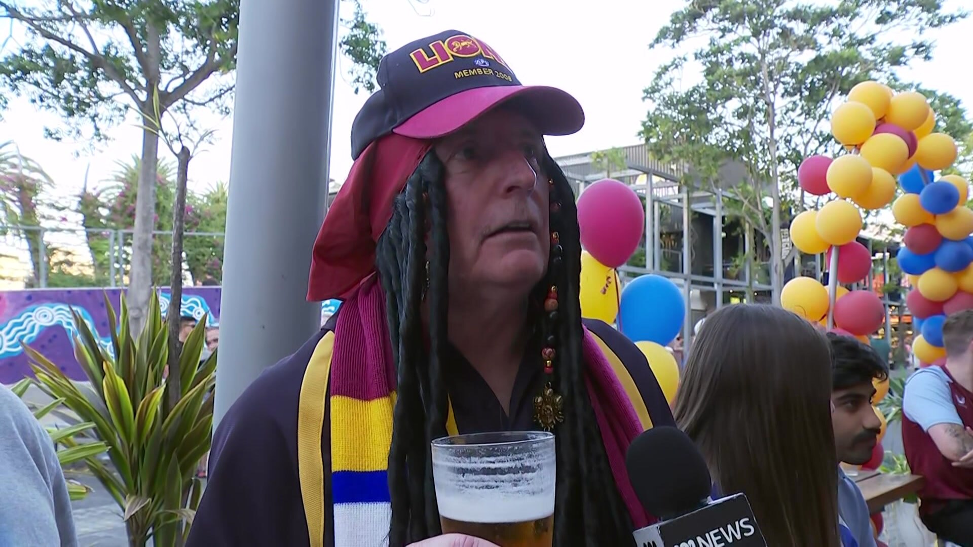 A man in a Brisbane Lions outfit.