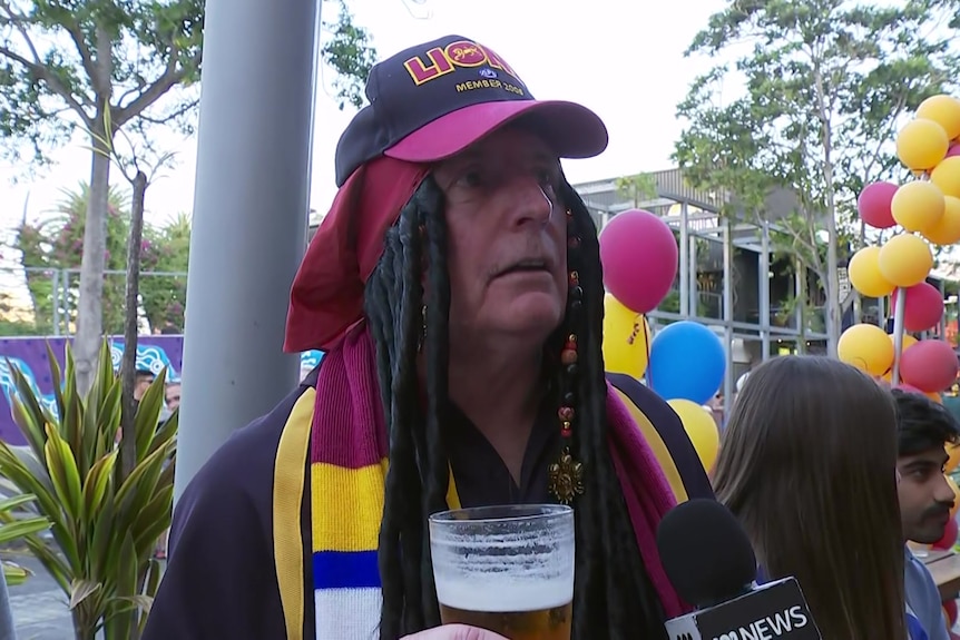 A man in a Brisbane Lions outfit.