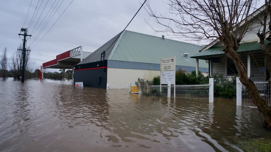 A submerged house and service station in the 2022 floods at Camden.