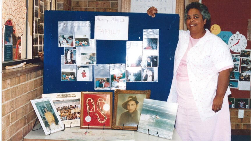 Dr Alice Rigney standing by a pinboard