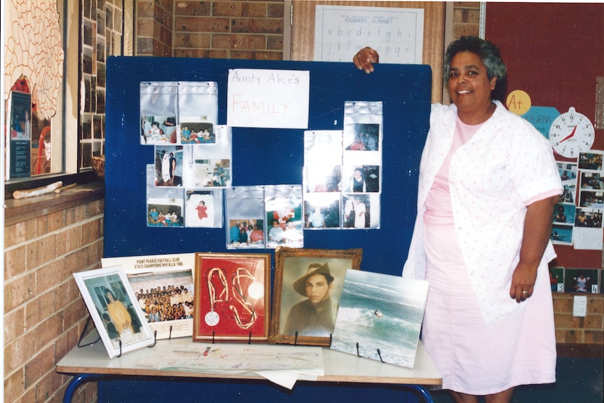 Dr Alice Rigney standing by a pinboard